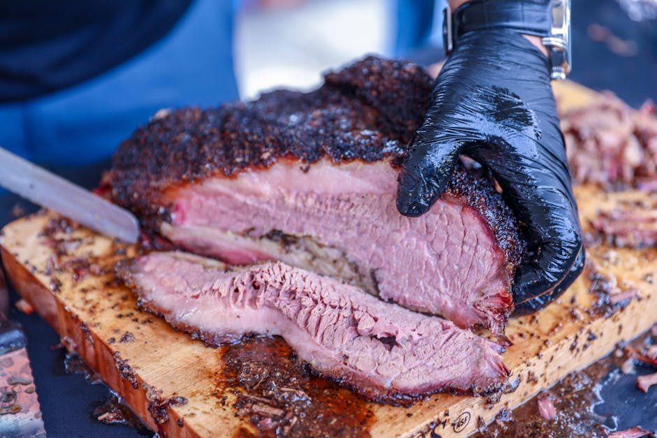 Slow-smoked brisket being sliced for service