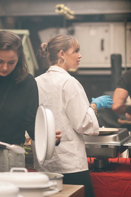 Kitchen team preparing food for large event